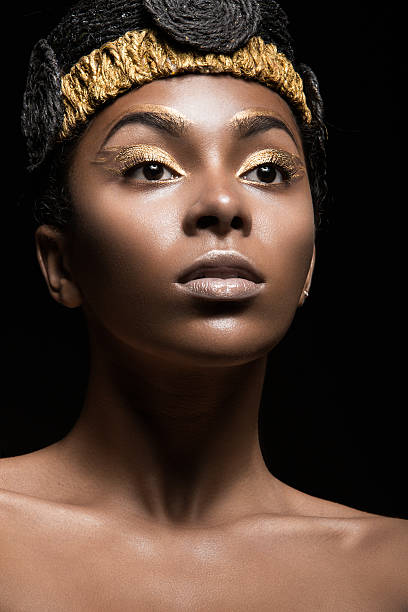 istock African girl with bright makeup and creative gold accessories on 483530774