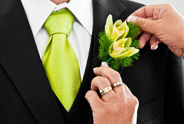 Pinning a Boutonniere on the Groom