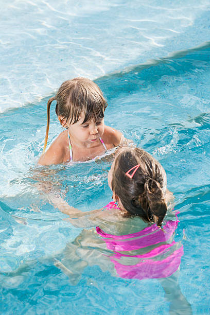 istock Two little girls in swimming pool 483531569
