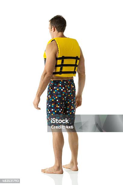 Rear View Of Man Wearing Life Jacket Stock Photo - Download Image Now - Life Jacket, White Background, 20-29 Years
