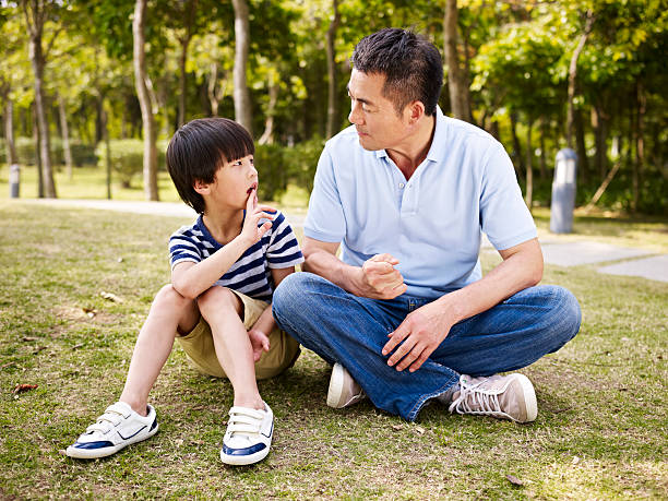 istock asian father and son having a conversation 483537050