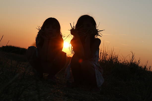 istock Two girls at sunset 483543272