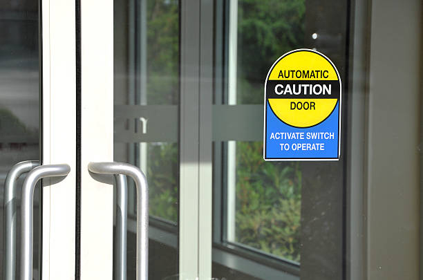 Automatic door with caution sign stock photo