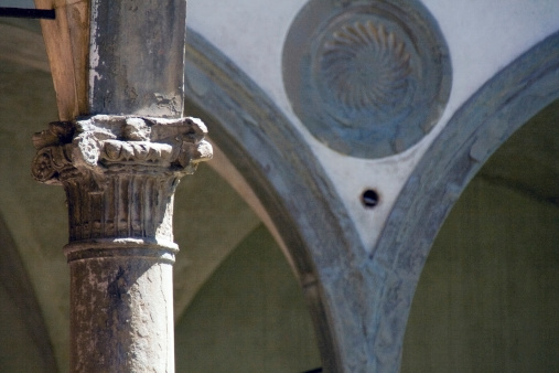 Arch and column from the renaissance period at the Cloister of Santa Croce church, built by Brunelleschi. Florence,  Italy.
