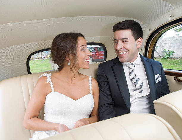istock The bride and groom smiling inside a car. 483546459