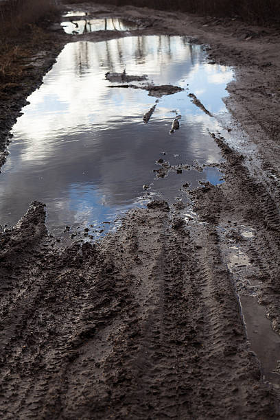 istock Mud and puddles on the dirt road 483546544