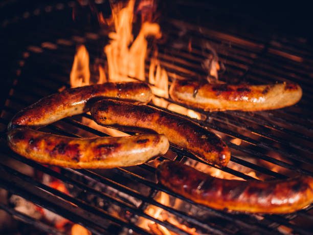 istock Sausages being grilled on a firey barbecue 483546604