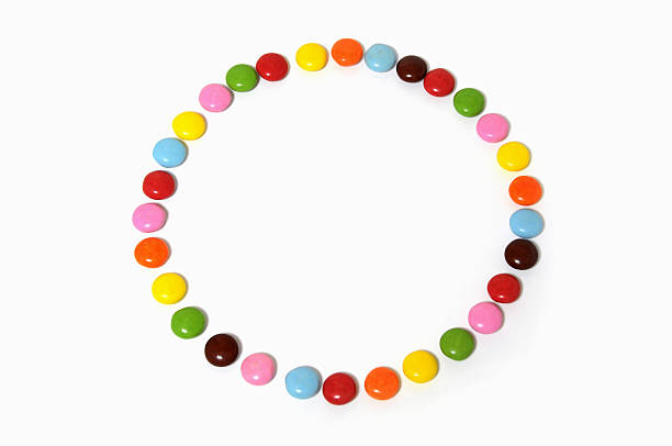 istock circle of colorful chocolate candies spread on white background 483546773