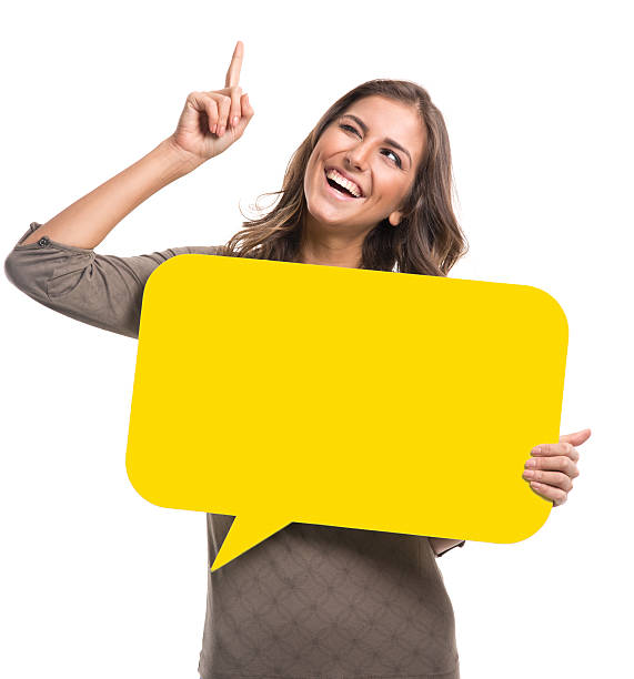 istock Young woman holding yellow speech bubble 483550564