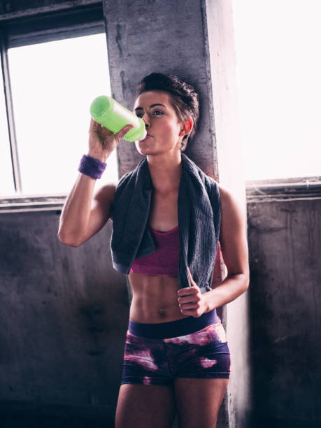 istock Thirsty girl drinking from a water bottle after exercising 483550912
