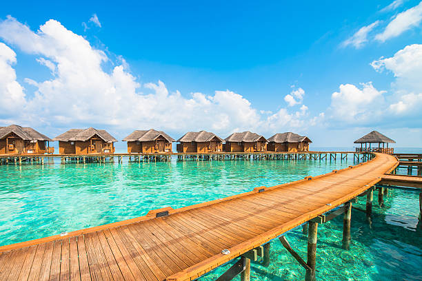 istock Over water bungalows with steps into amazing green lagoon 483551392