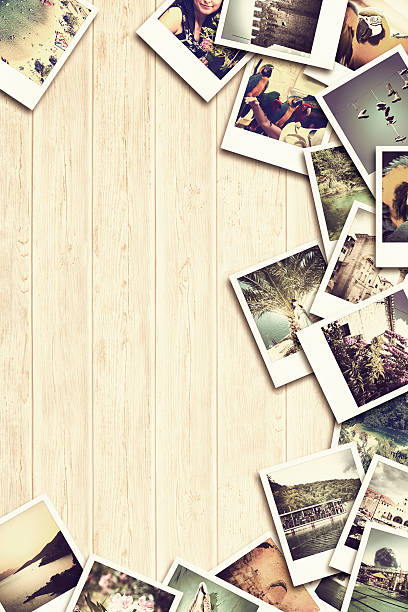 istock Frame with old paper and photos on wooden background. 483551536
