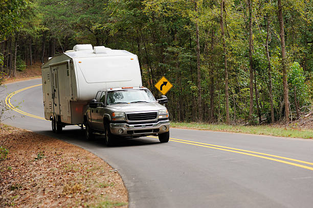 a truck towing a travel trailer on a scenic road