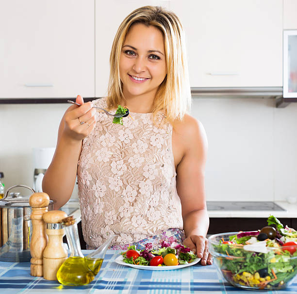istock Woman enjoying vegetable salad 483555504
