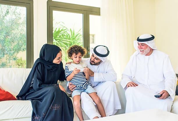 Child with parents playing game on smart phone stock photo