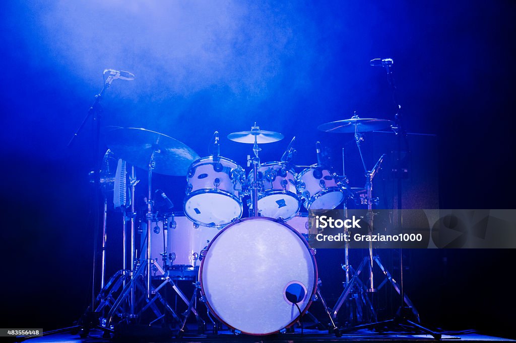 Drum Kit Full rock drum kit on stage with blue lighting and no drummer Drum Kit Stock Photo