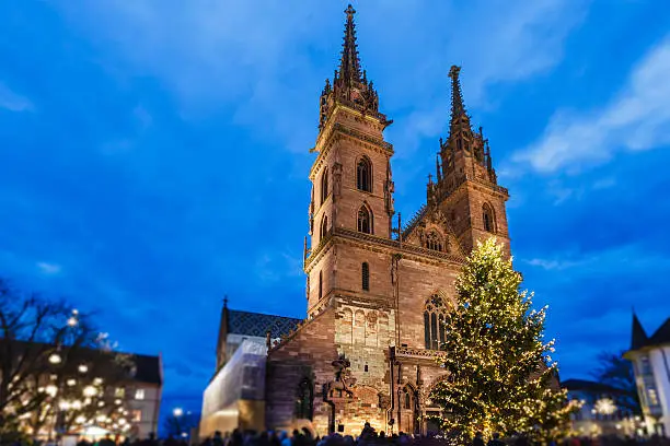 Christmas tree in front of the Basel Minster, in Münsterplatz, where a charming Christmas market is held. Basel is one of the largest and populated cities of Switzerland. It is located in the northwest of the country, on river Rhine and right on the Swiss-French-German border.