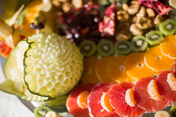 Exotic fruit decoration table Exotic fruit decoration table fruit carving stock pictures, royalty-free photos & images