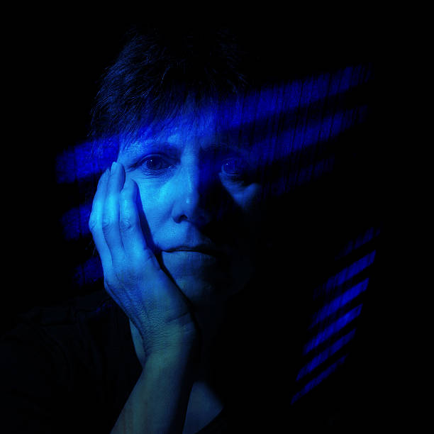 istock Feeling blue - older women in shafts of light effect 483558532