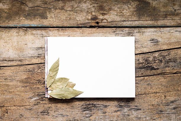 istock Blank White  Sketchpad with bay leaf on wooden background 483558733