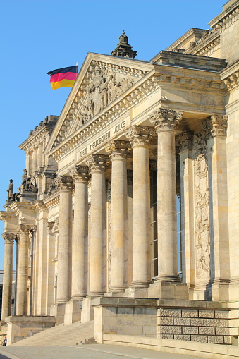 side view of the berlin reichstag building with german flag