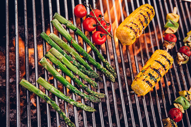 istock Barbecue grill with asparagus, corn, vine tomatoes and vegetable kebabs 483558950