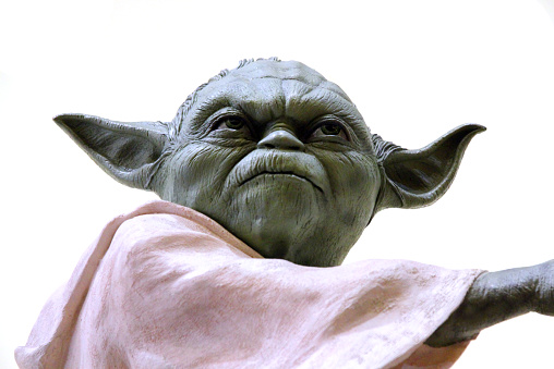 Vancouver, Canada - May 20, 2013: A model of the character Yoda, from the Star Wars Film Franchise, against a white backgroud.