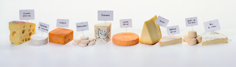 Various types of french cheeses on white background.