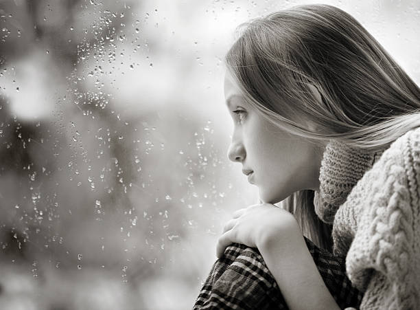 istock Rainy Day: sad Girl on the Window 483562227