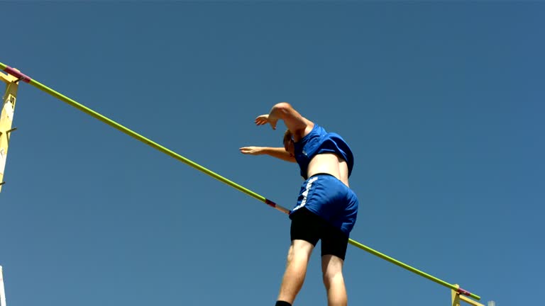 Track and Field athlete doing pole vault, slow motion