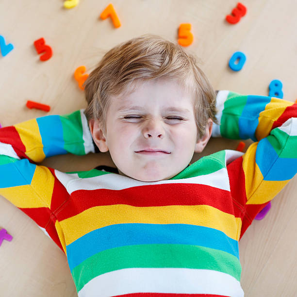 istock Kid boy with colorful numbers, indoor 483562940