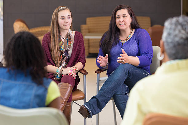 istock Mother talking about parenting relationship in support group meeting 483563237