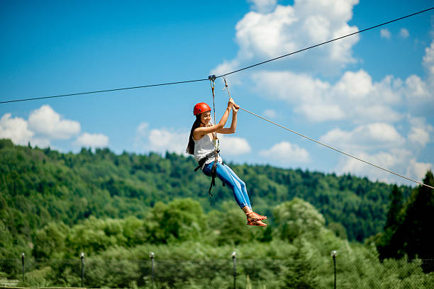 Riding on a zip line stock photo
