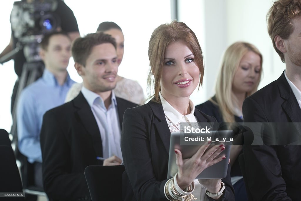Conference Group of business people attending press conference or presentation. Adult Stock Photo