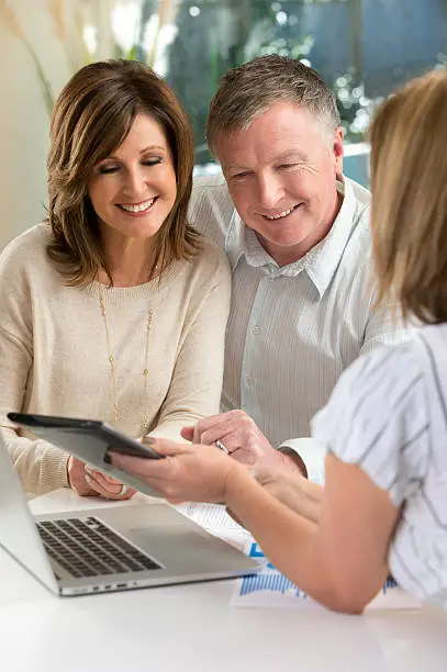 Photo of Happy mature Couple in Meeting With Advisor