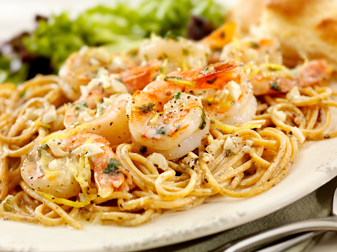 Shrimp Scampi in a Butter and White Wine Sauce with Garlic, Pepper, Lemon Zest and Fresh Parsley on top of Whole Wheat Pasta -Photographed on Hasselblad H3D2-39mb Camera