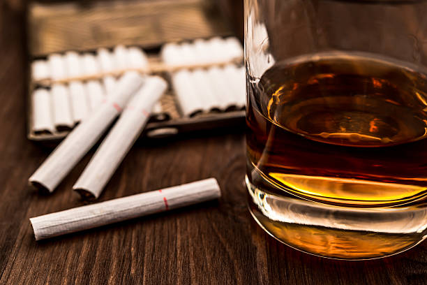 istock Glass of whiskey and cigarettes with a cigarette case 483572382