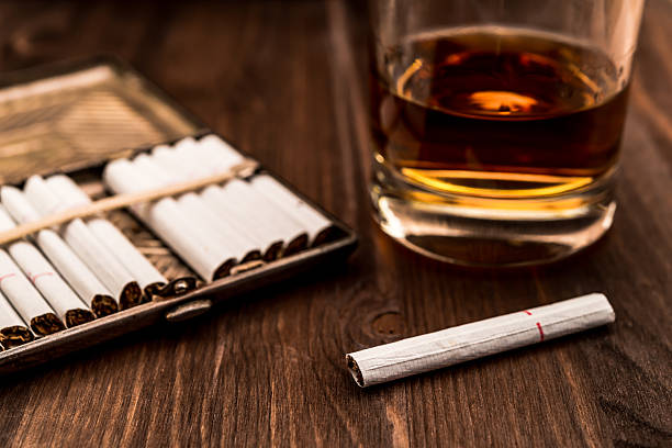 istock Glass of whiskey and cigarette with a cigarette case 483572444