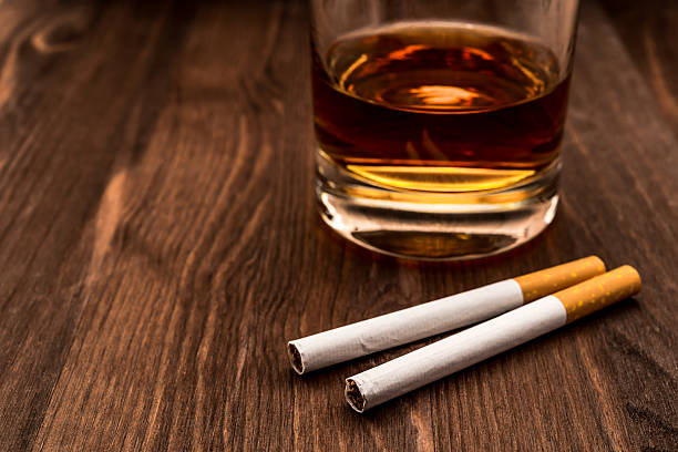 istock Glass of whiskey and two cigarettes 483572890