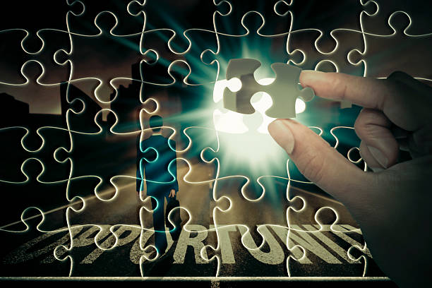 istock Hands placing last piece of a Puzzle 483574815