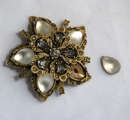 Old fashioned broken vintage brooch with moonstone inserts