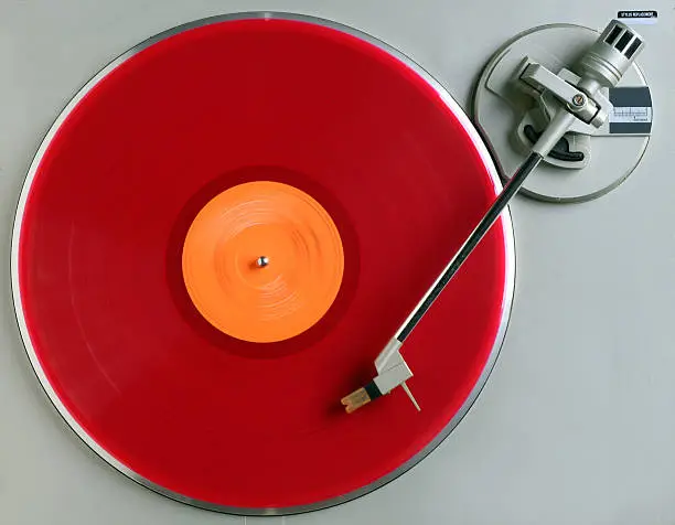 red vinyl album turning on recordplayer