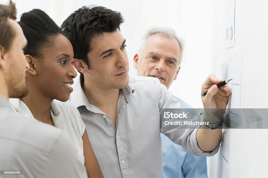 Business Team Analyzing Graph Group Of Business People Analyzing Graphs and Charts in Office Graph Stock Photo