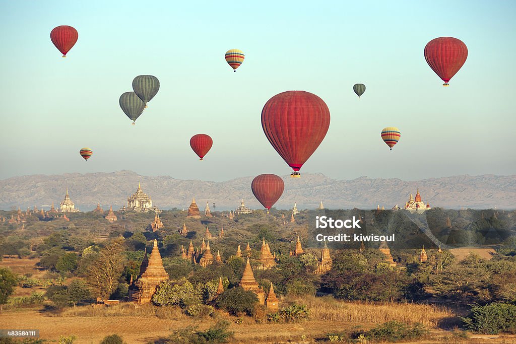 Multicolored Balloons Temples Bagan Multicolored hot air balloons over Buddhist temples at sunrise. Bagan, Myanmar. Canon 5D Mk II. Myanmar Stock Photo