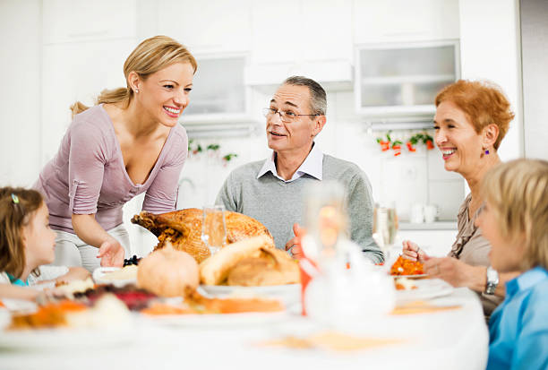 istock Family at the dinner table for Thanksgiving day. 483584565