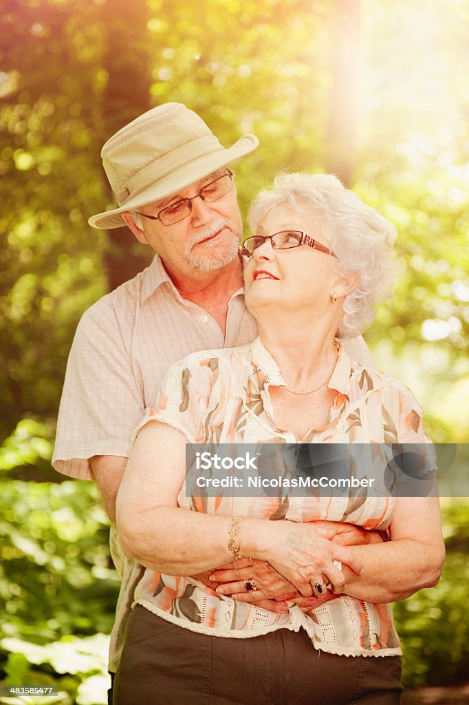 Senior outdoor romance A senior woman enjoys a surprise hug from her mate. Canada Stock Photo