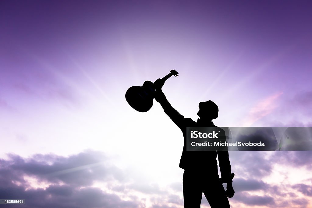 Silhouette of a Musician A silhouette of a musician against a beautiful sunset sky.  http://blog.michaelsvoboda.com/GuitarBanner.jpg Guitar Stock Photo