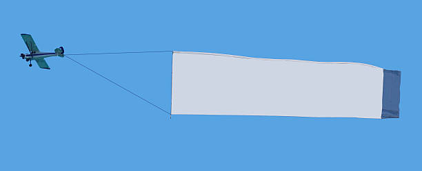 Sky message Airplane towing fabric billboard in the sky. Write your own message in the white space. words in the sky stock pictures, royalty-free photos & images