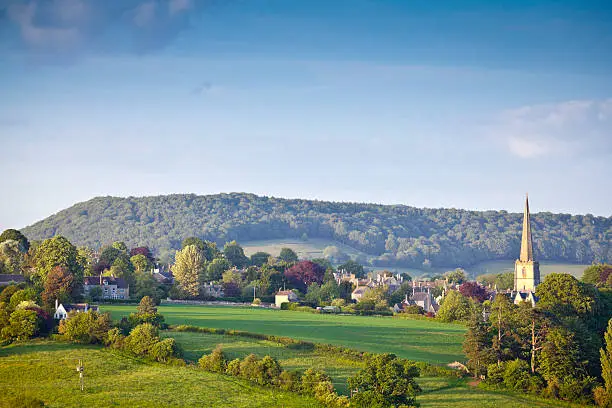 Idyllic rural view of gently rolling patchwork farmland and villages with pretty wooded boundaries, in the beautiful surroundings of the Cotswolds, England, UK.