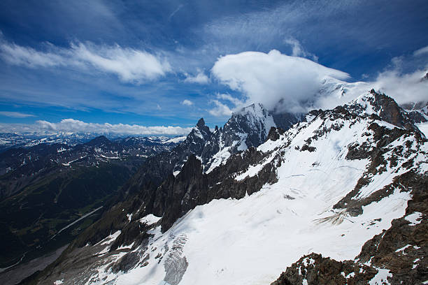 Clouded Mont Blanc peak and Aiguille Noire de Peuterey stock photo